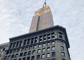 A stunning low-angle shot of the Empire State Building towering above the New York skyline.